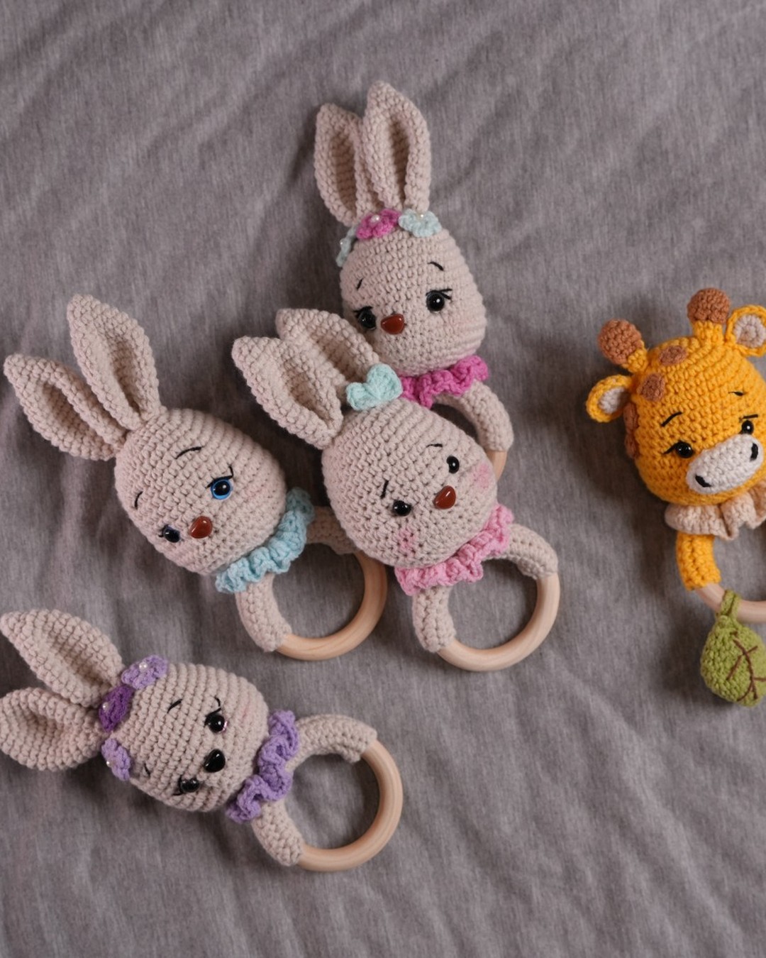 Five handmade crochet baby teethers with wooden rings including Gigi the giraffe