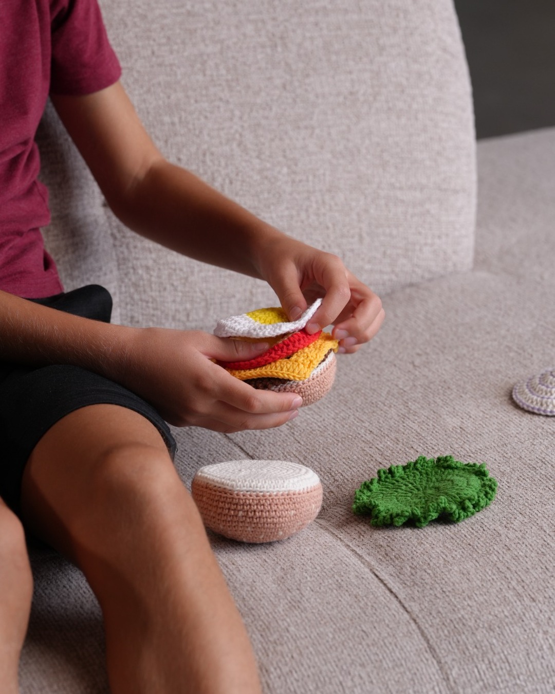 Handmade crochet burger stacked with lettuce, cheese, and patty