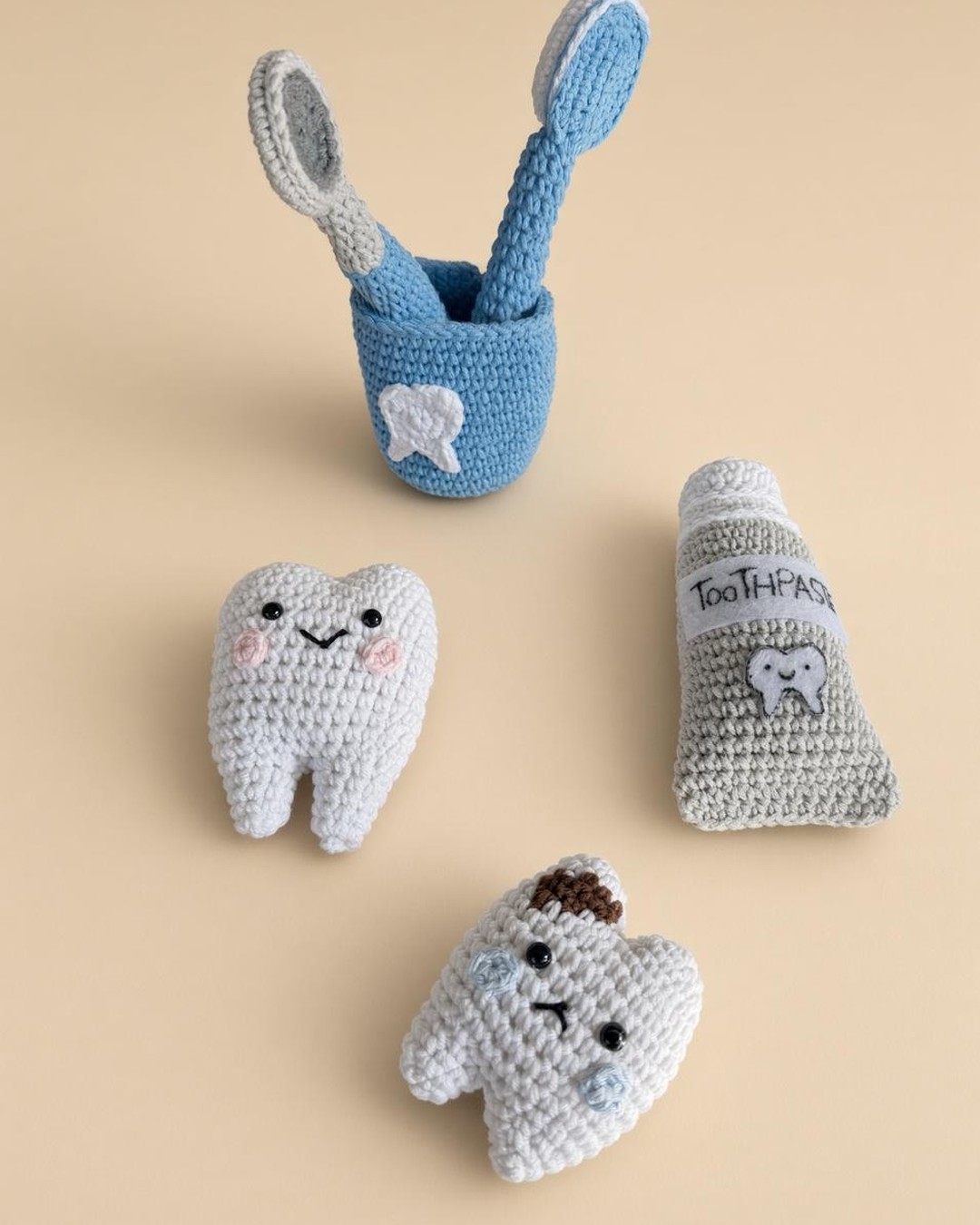 Handmade crochet dentist set: blue cup with toothbrush and mirror, happy tooth, tooth with a cavity and toothpaste tube