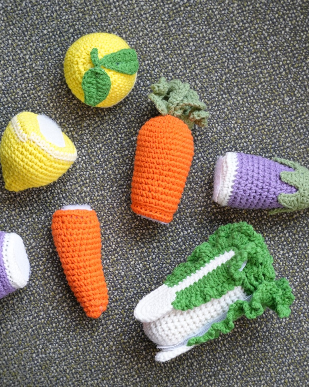 Handmade crochet cut-and-play vegetables — carrot, eggplant, lemon, and greens