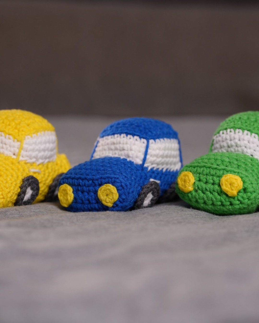 Set of handmade crochet toy cars in bright colours